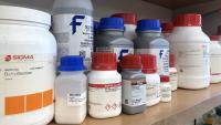 Chemicals used for experiments on a lab shelf.